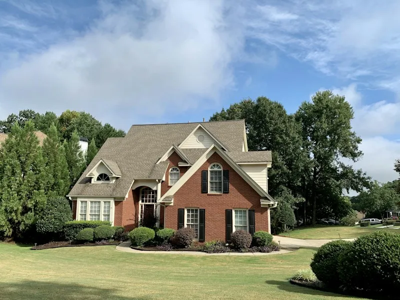 Traditional brick two-story home with a tidy front yard